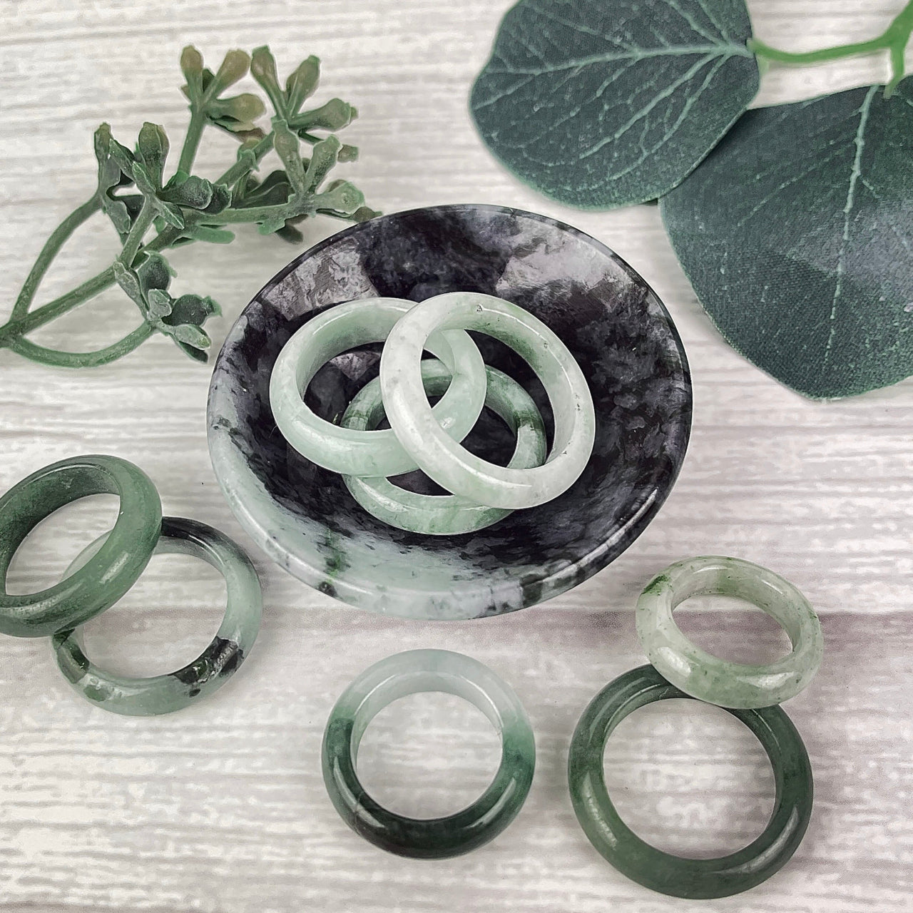 A couple of jade polished rings sitting on top of a table, perfect for any occasion