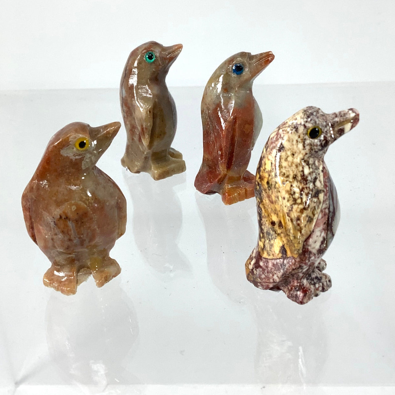 Soapstone baby animal carving from Peru showcasing three small birds sitting on a table