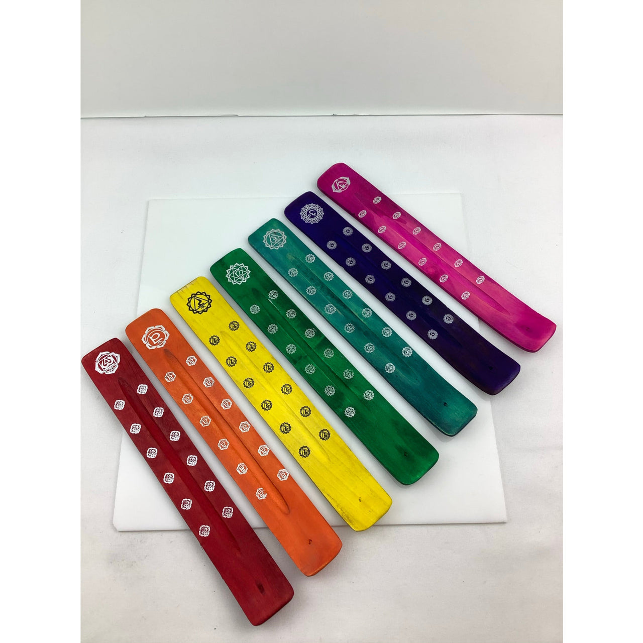 Colorful wooden pegs, painted for 1 Wood Incense Holder #HC003; bright and vibrant on white background