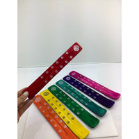 Thumbnail for Hand holding a colorful tie, promoting the 1 Wood Incense Holder–Painted Color #HC003