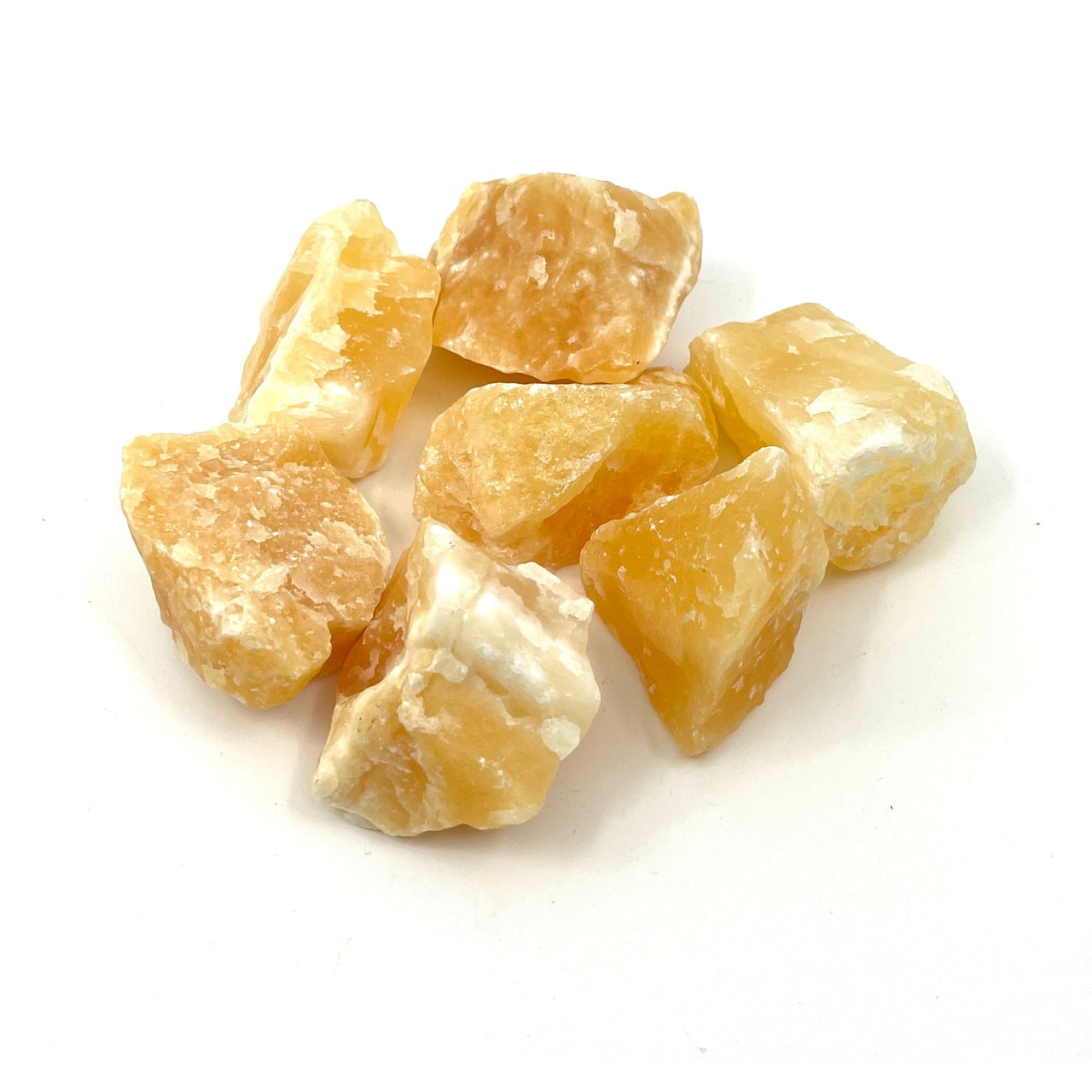 Sliced peeled oranges on white surface, featured with 2 Orange Calcite Rough Chunks (54g) #LV1143