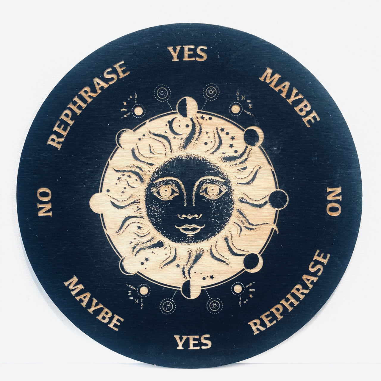 Black and white circular sign with a sun and moon on the 6’ Sun + Moon Pendulum Board