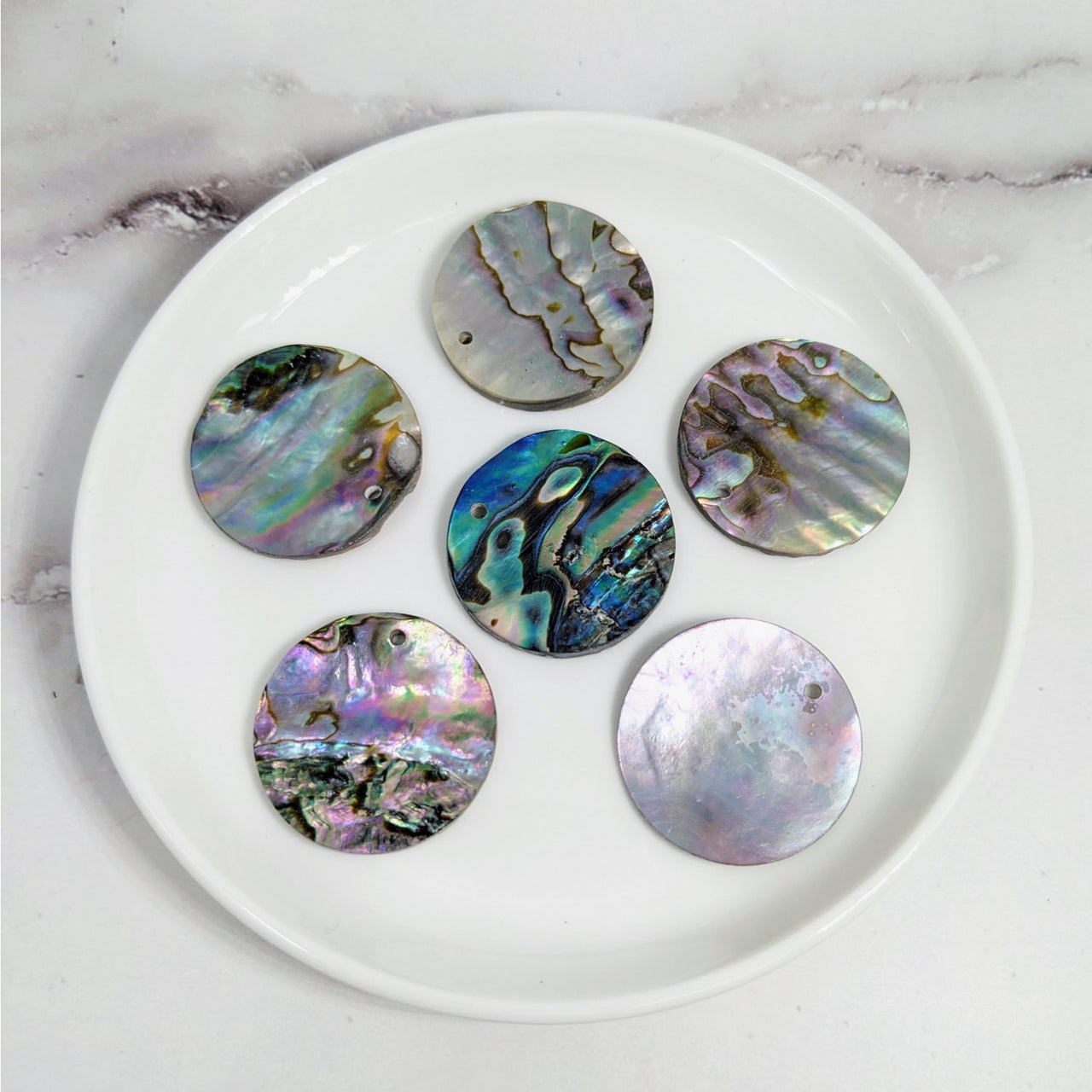 Colorful Abalone Shell 6 Pack Top Drilled Disc Bead #LV3603 close up on a plate