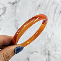 Thumbnail for Hand holding Agate Round Bangle Crystal Bracelet #LV1969 with banded agate and orange-blue bang