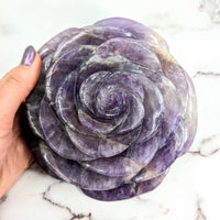 Thumbnail for Person holding Amethyst Jumbo Rose Carving showcasing a purple rock in rose shape