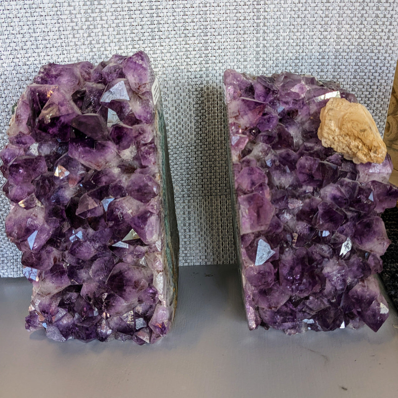 Amethyst Geode Bookends #LV5419: Two amethyst crystals on a table