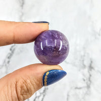 Thumbnail for Hand holding purple and blue gems: Amethyst Sphere w/ Stand #LV1973