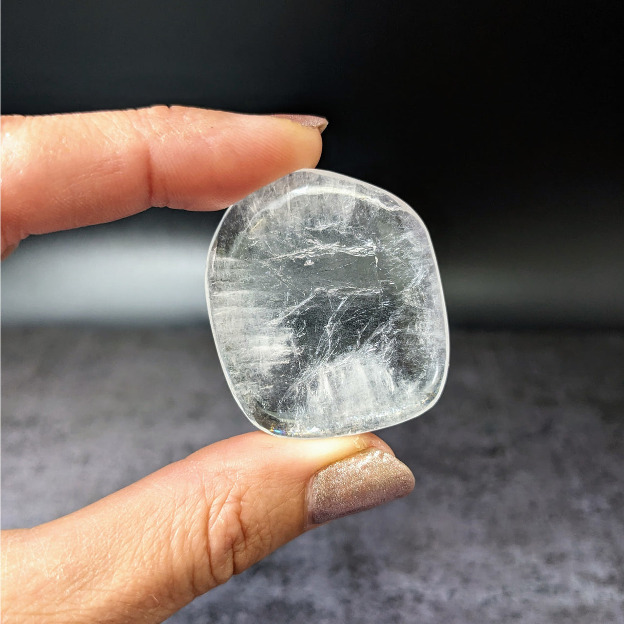 Person holding ice-like Apophyllite Gem A+ tumbled stones #LV3891