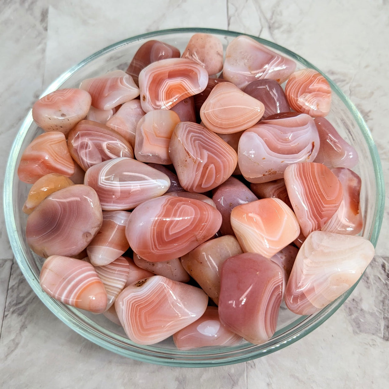 A bowl of pink and white marble Apricot Agate Tumbled Stones #LV2261