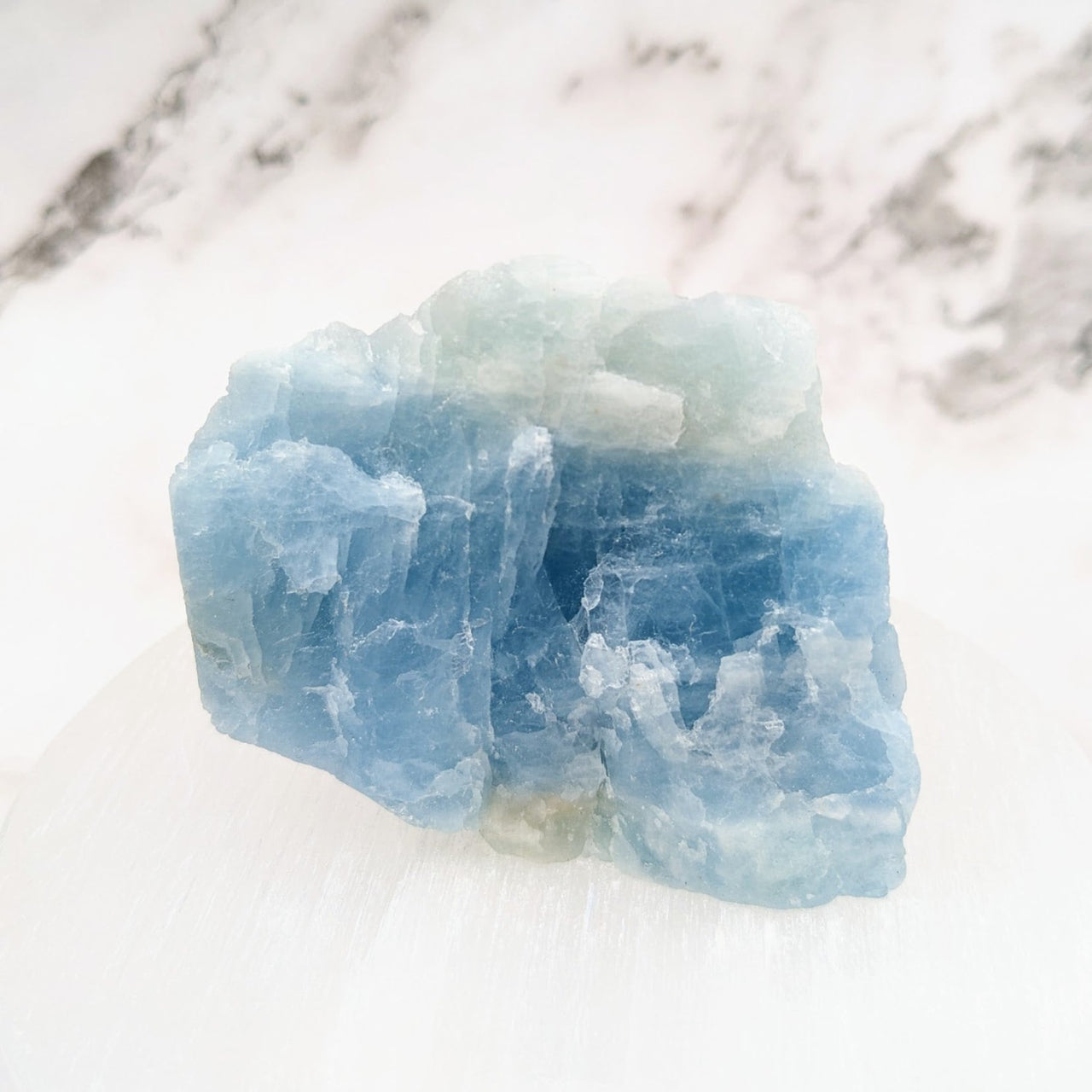 Aquamarine 2.7’ Rough Specimen #LV4621: Blue Ice Cube on White Marble Surface