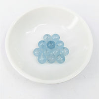 Thumbnail for A white plate with blue glass pebbles from the Aquamarine 8 mm Round Bead 6 pack #LV3635