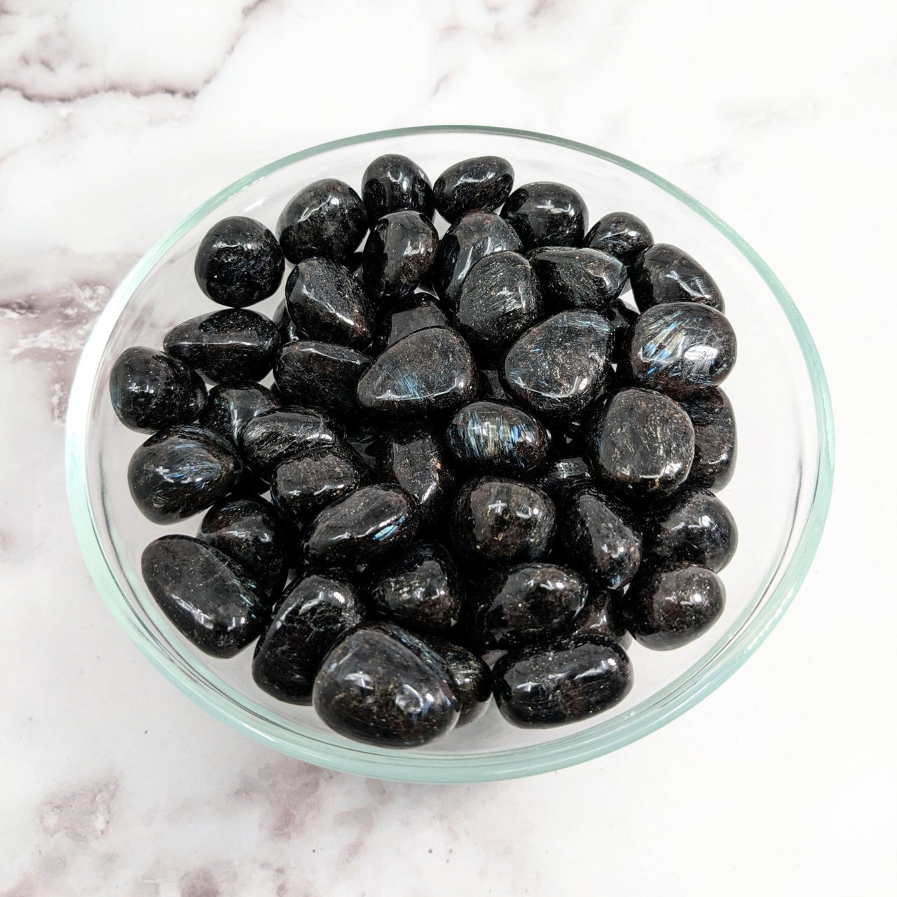 Black tumbled stones in a glass bowl - Arfvedsonite .80’ - 1’ Tumbled Stone #LV2139