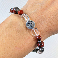 Thumbnail for Woman’s hand wearing Aries Zodiac Handmade Beaded Bracelet with red and black glass beads