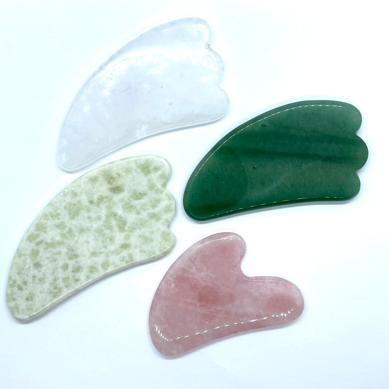 Assorted Crystal Gua Sha Massage Tool #K166 with three colored stones on white background