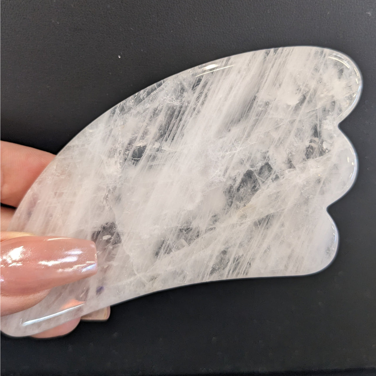 Person holding marble piece from Assorted Crystal Gua Sha Massage Tool #K166