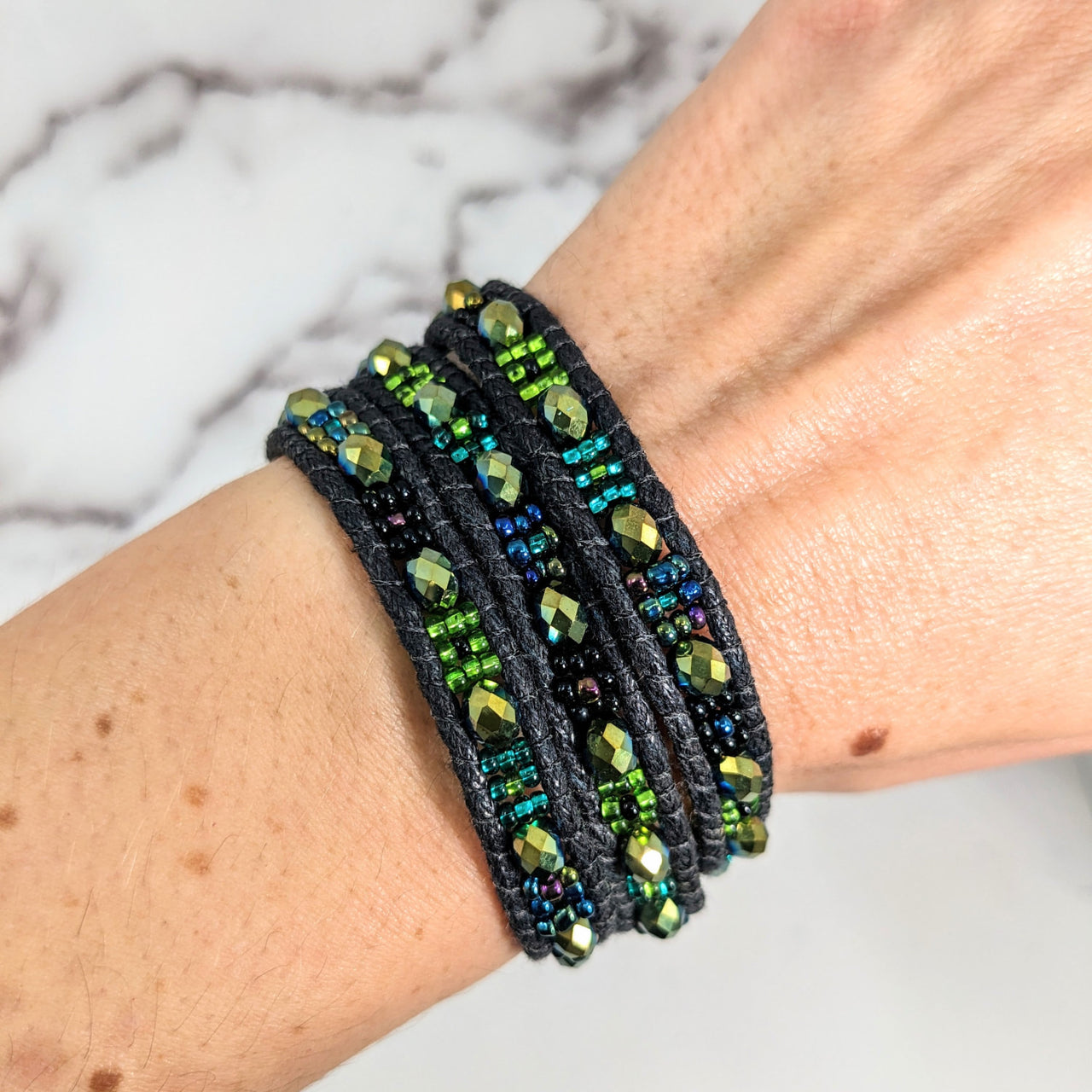 Woman wearing Beaded Triple Wrap, Woven 7’ Bracelet #LV2656 with green and blue beads