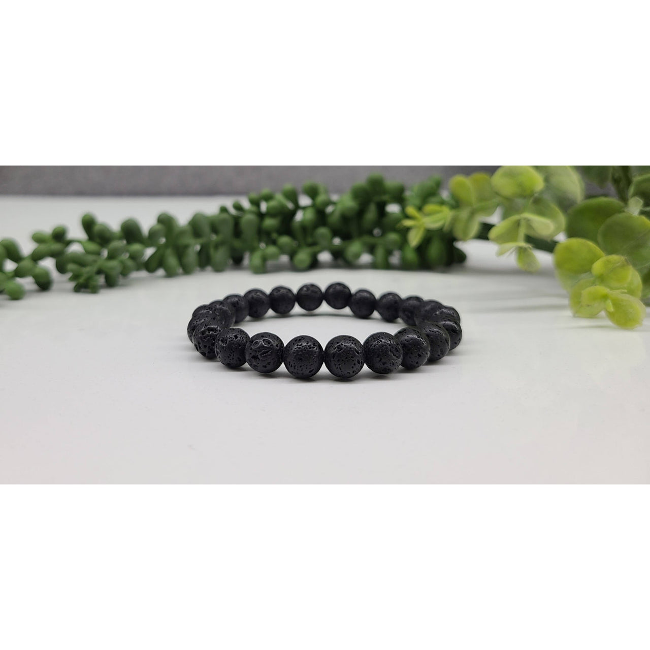 Close-up of Black Lava Rock Beaded Bracelet on Table | Product #LV5331