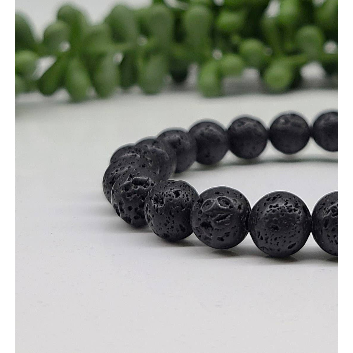 Black lava rock beaded bracelet with 8mm lava beads on a table #LV5331