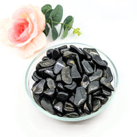 Thumbnail for Black Lemurian Jade tumbled stones in a bowl with a rose, perfect for crystal healing