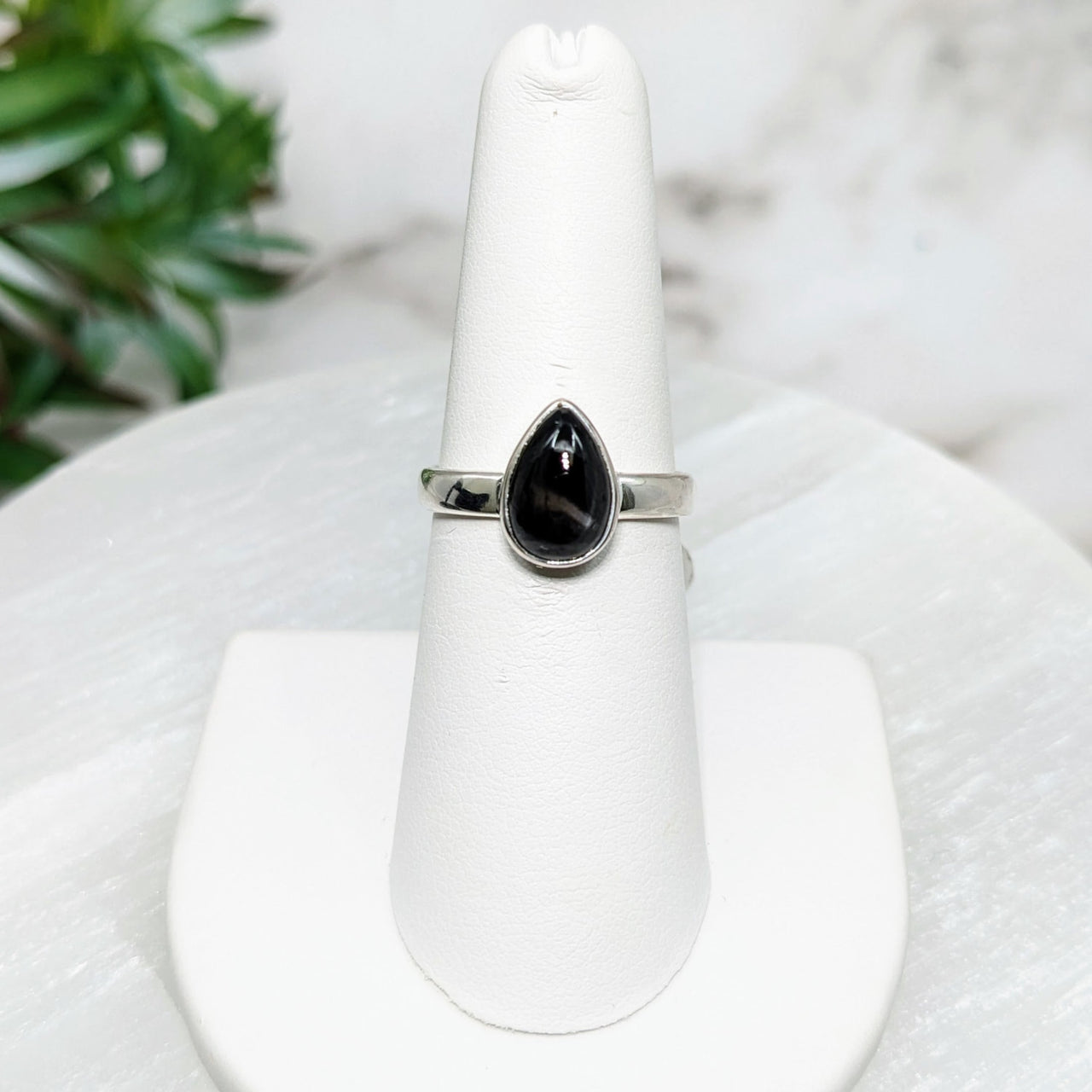 Black Star Sapphire S.S. Teardrop Ring #LV5010 onyxite stone on white pedestal