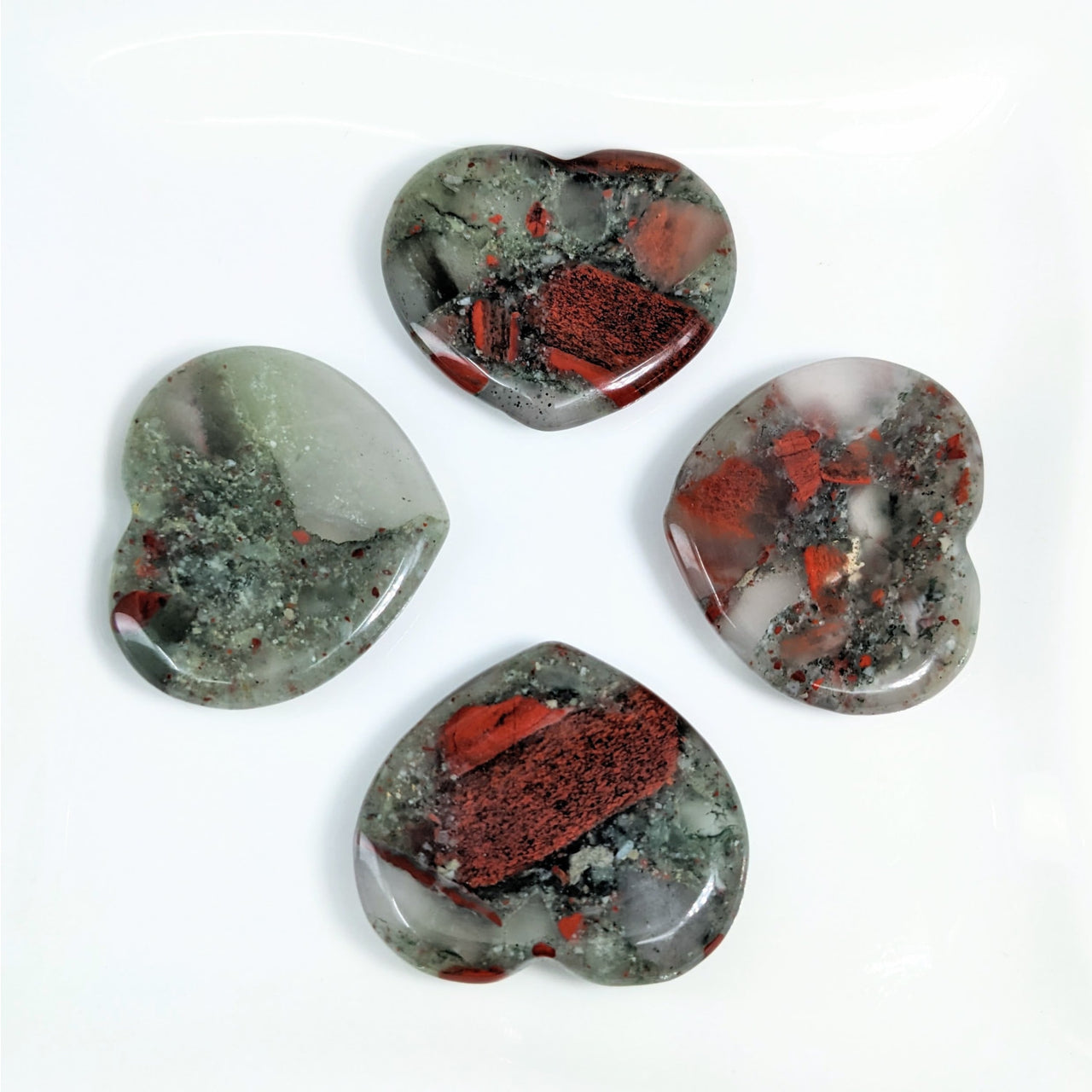 Bloodstone 1.5’ Heart Thumb Stone #LV4148 with red and green stones on a white surface