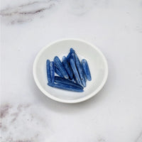 Thumbnail for Blue kyanite chips on a white plate from Blue Kyanite Blade Top Hole Drilled Bead 12 Pack