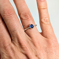 Thumbnail for A woman’s hand wearing a sterling silver blue kyanite ring named Blue Kyanite Ring #J510