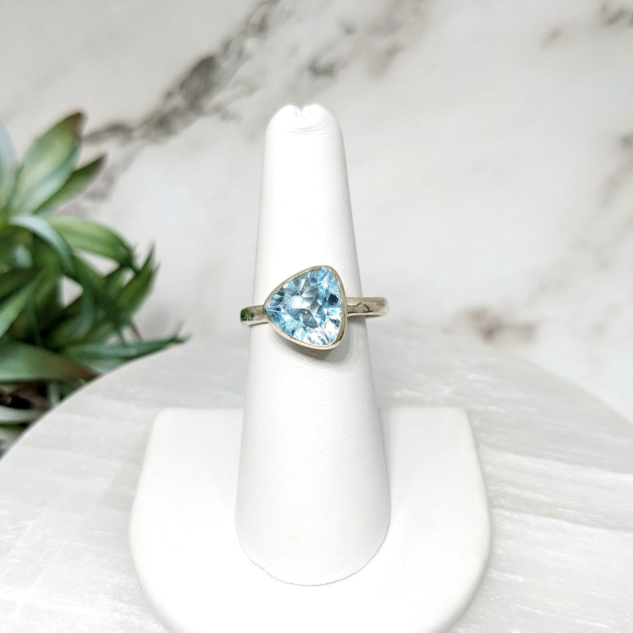 Blue Topaz Trillion Ring #LV4472 on a white pedestal