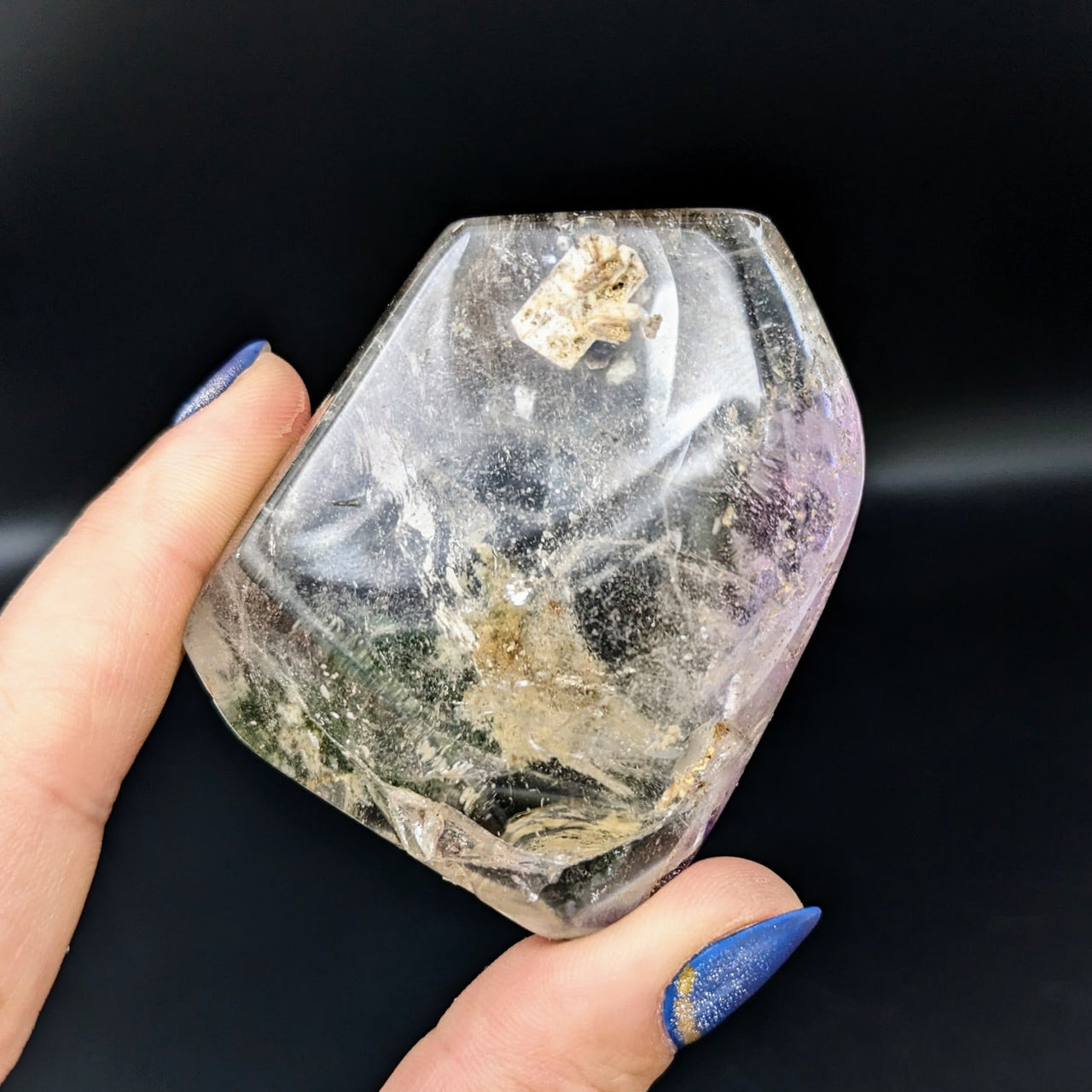 Person holding Brandberg Amethyst 2.5’ Polished Pebble #LV1807 with a small rock inclusion