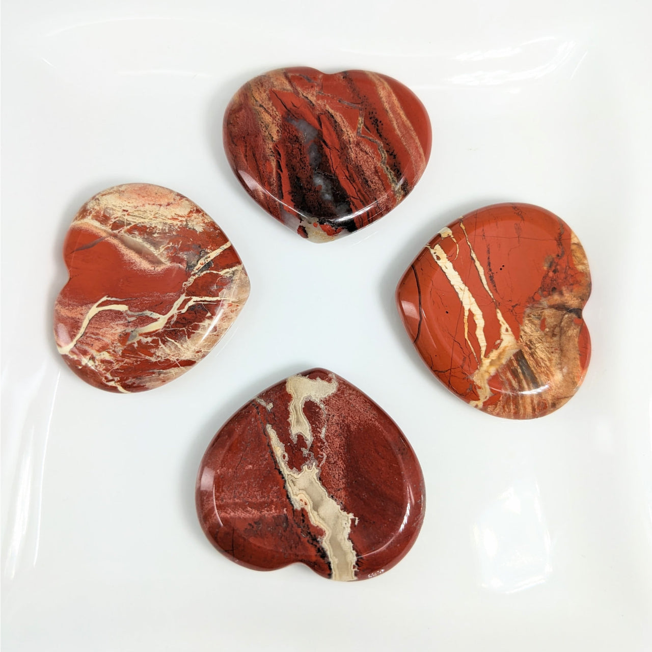 Brecciated Jasper 1.5-1.6’ Heart Thumb Stones on White Plate - Product #LV4147