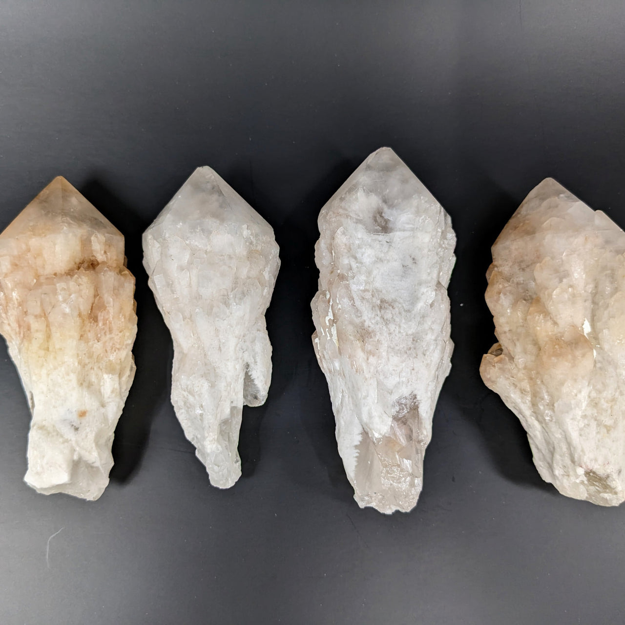 Three large rough point quartz crystals from Candle Quartz 3-5’ #LV2411 on black background