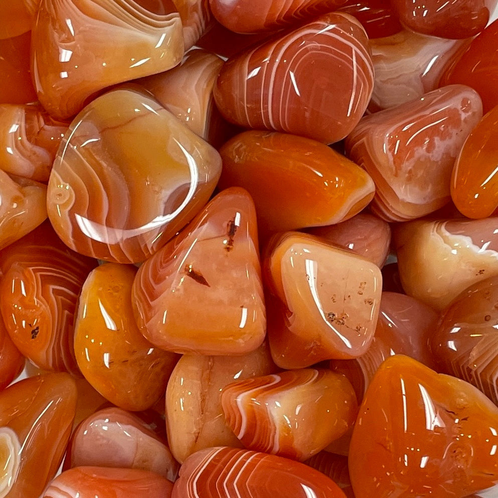 Close-up of Carnelian Banded Tumbled Stone #T510 showing orange and white rocks