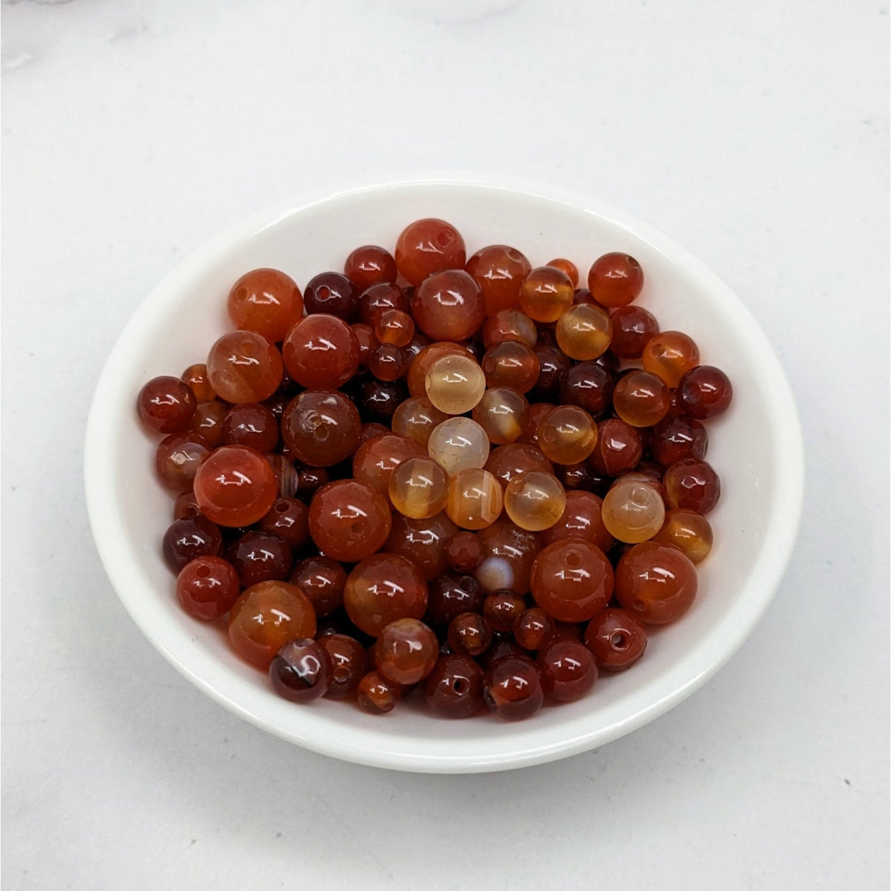 A bowl of red and yellow olives from Carnelian Bead Assorted Size 12 Pack #LV3660