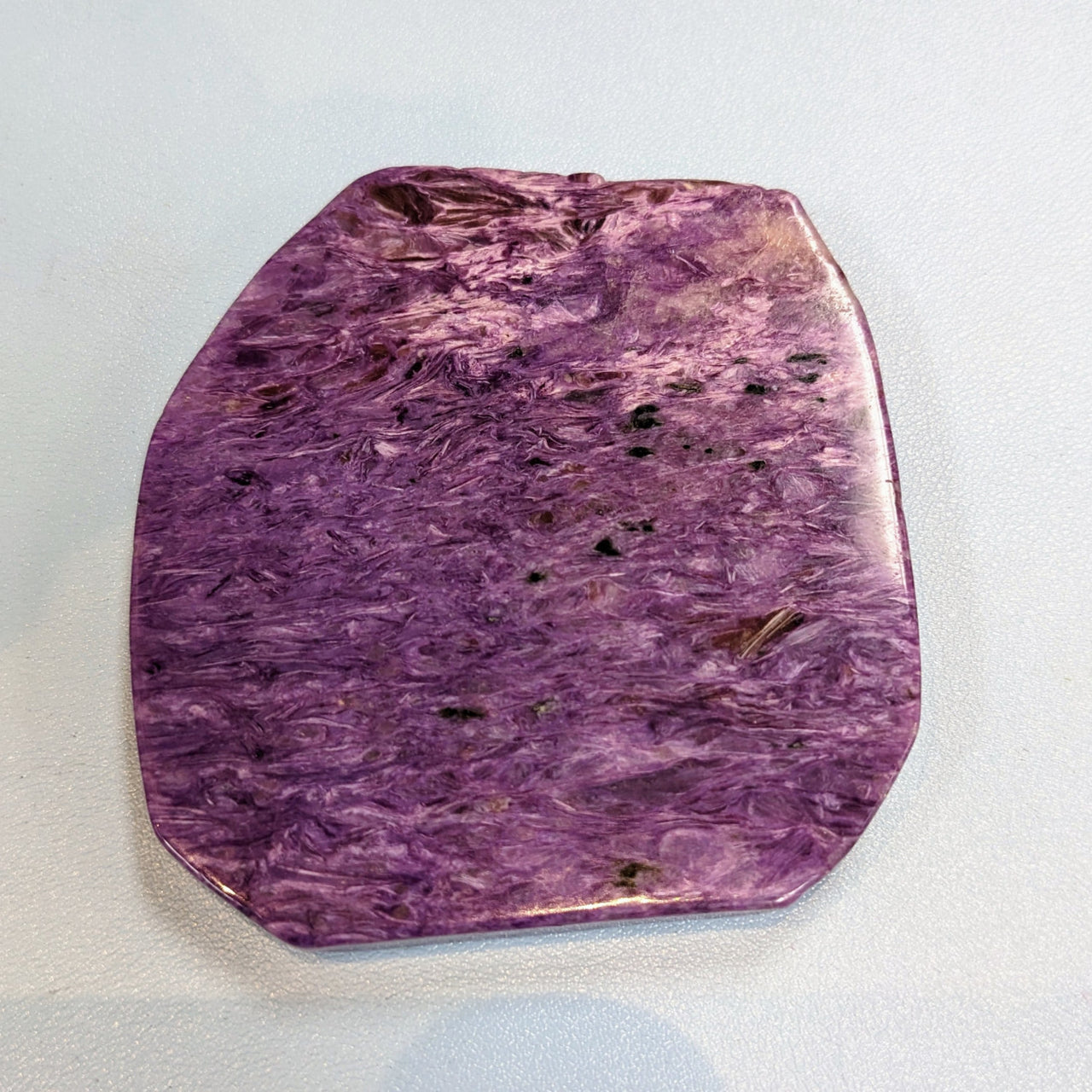 Flat-shaped Charoite slab Grade AA M176 with purple hue and black dots