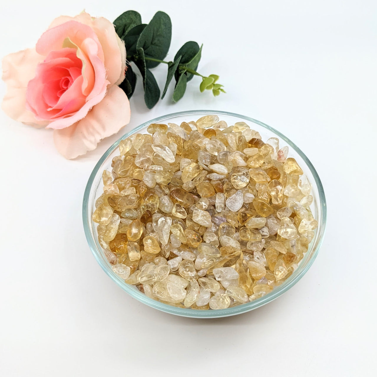 A radiant bowl of yellow citrine crystals paired with a rose, featured as Citrine Fire & Ice Gravel