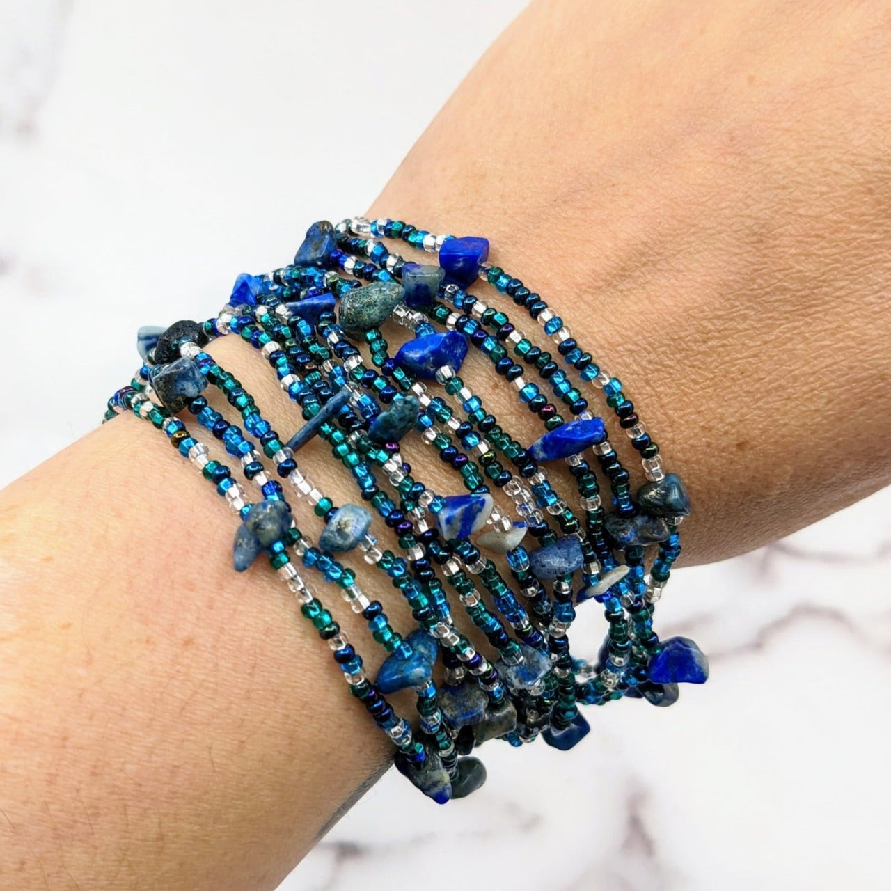 Woman wearing Crystal Beaded 12 Strand 8’ Bracelet w/ Magnet Clasp #LV1805 with blue beads