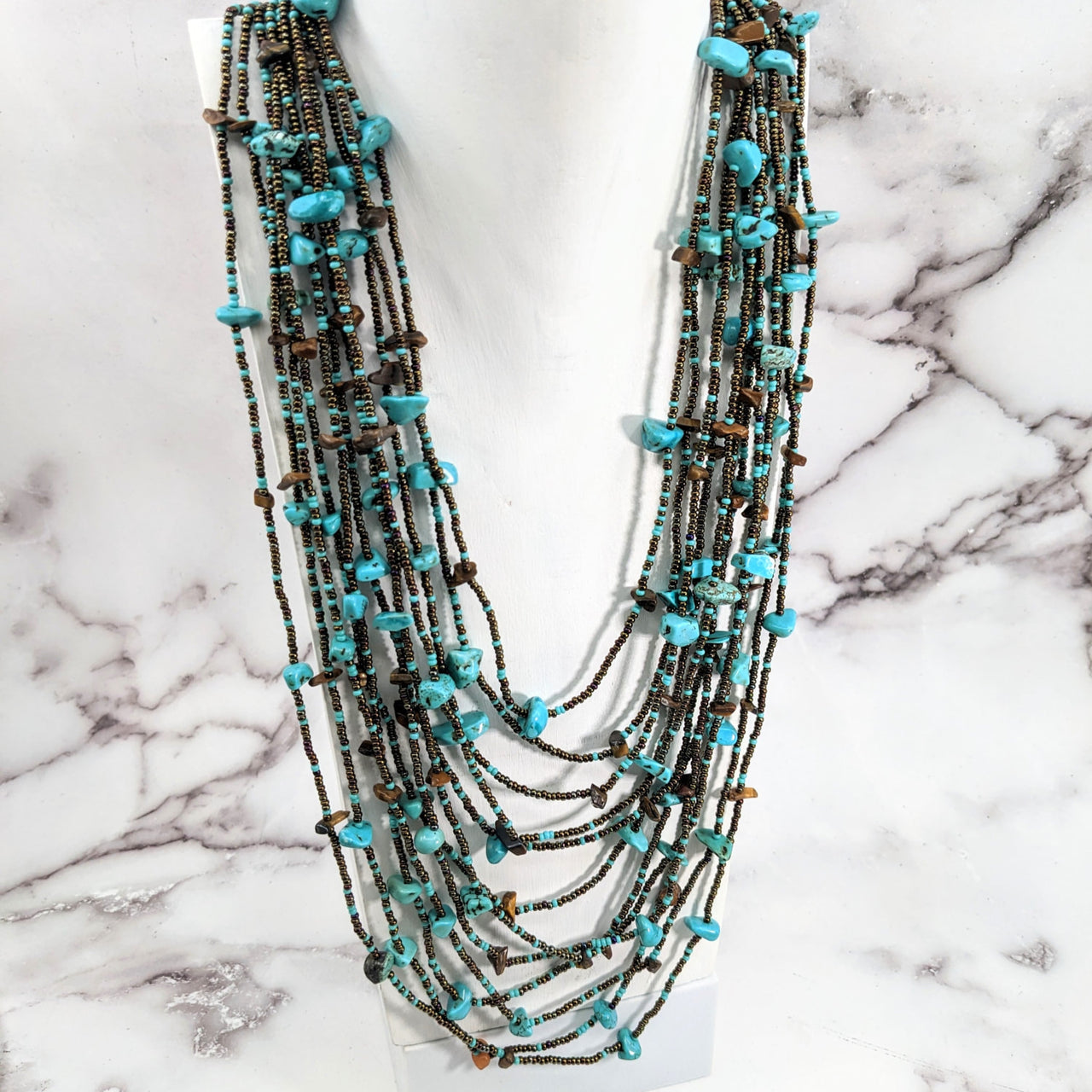 Turquoise and bronze Crystal Beaded 30’ 12 Strand Necklace #LV2655 displayed elegantly