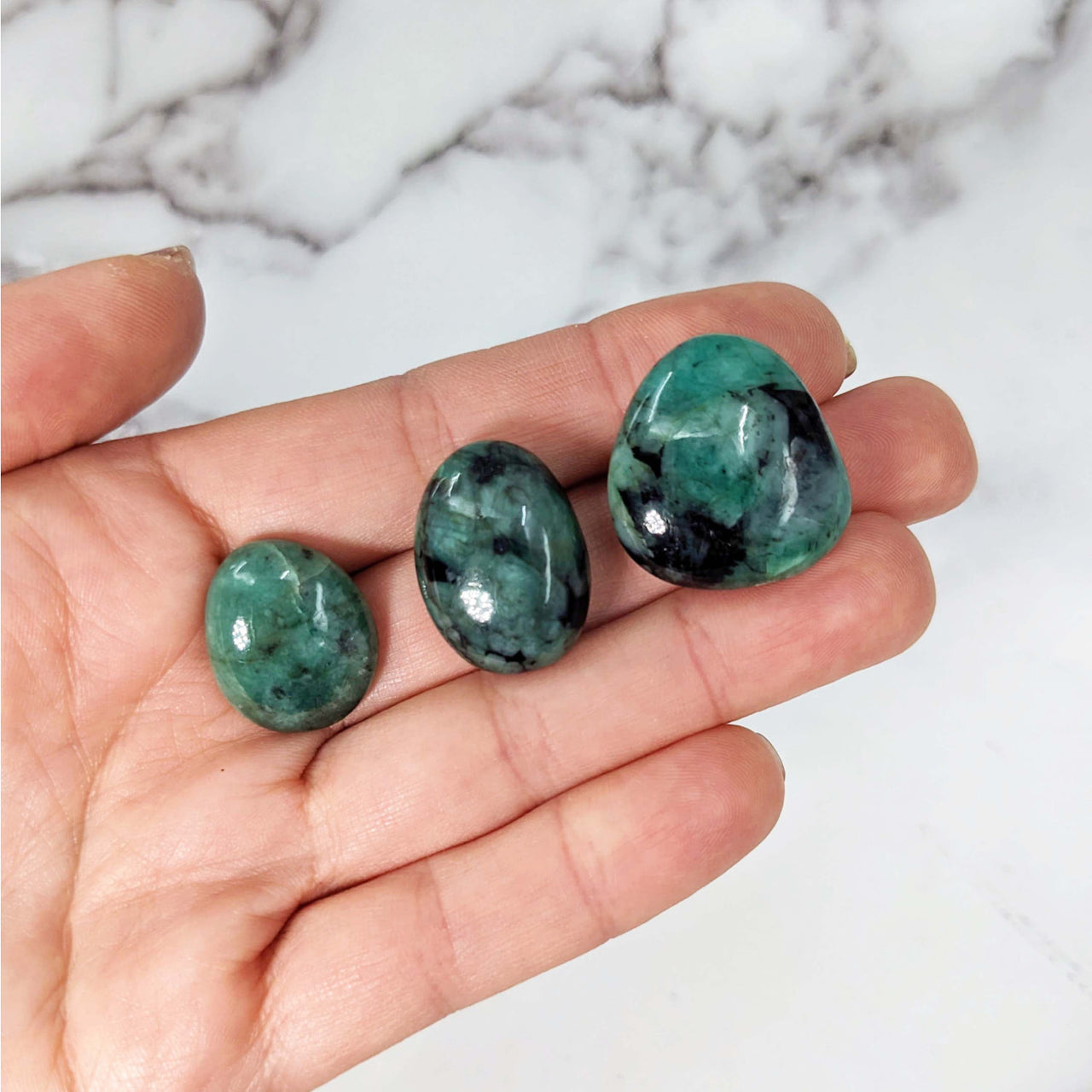 Two green avereite tumbled stones in hand - Emerald A+ Tumbled Stone #LV3886