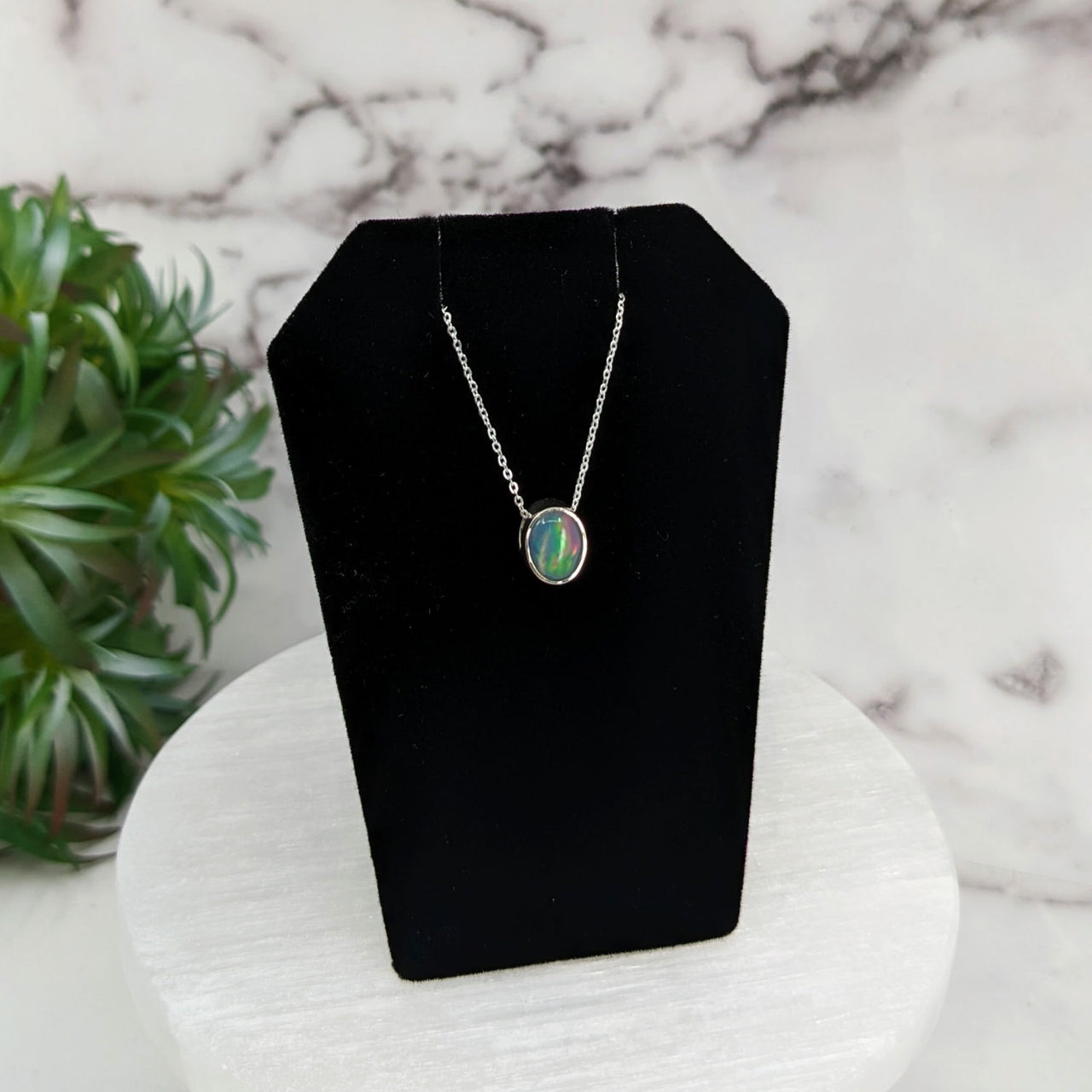 Ethiopian Opal Necklace with Green and White Pendant on Black Display Stand - Sterling Silver