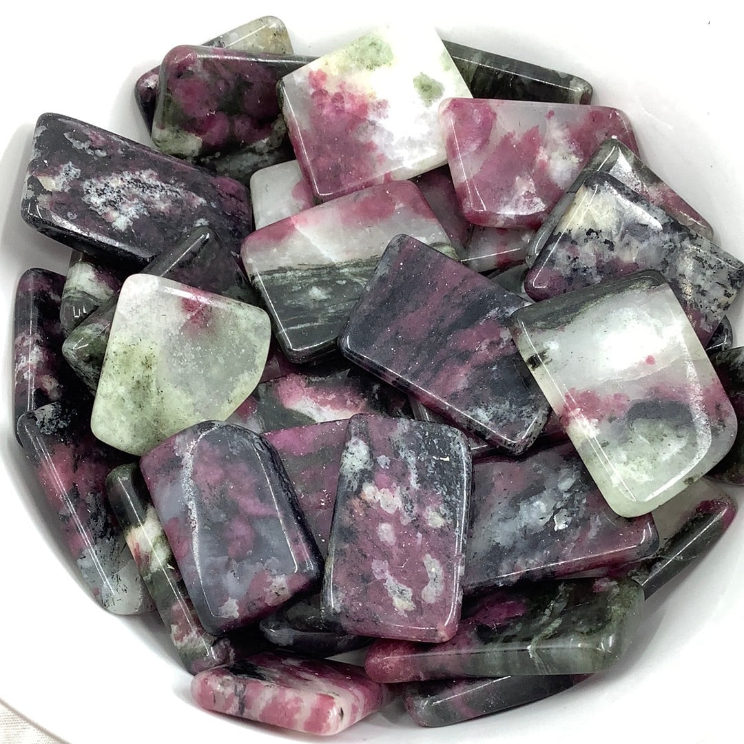 Eudialyte Polished Slice Stone TS036 - a bowl of vibrant purple and green crystal gemstones