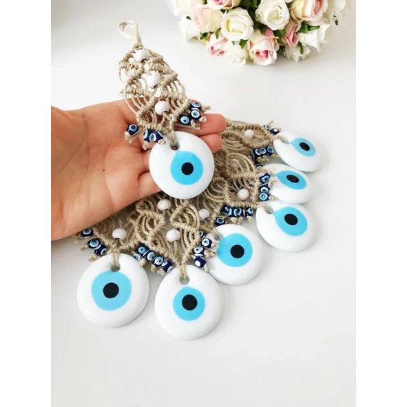 A hand holding a bunch of blue eyes from Evil Eye Wall Hangings #Q224