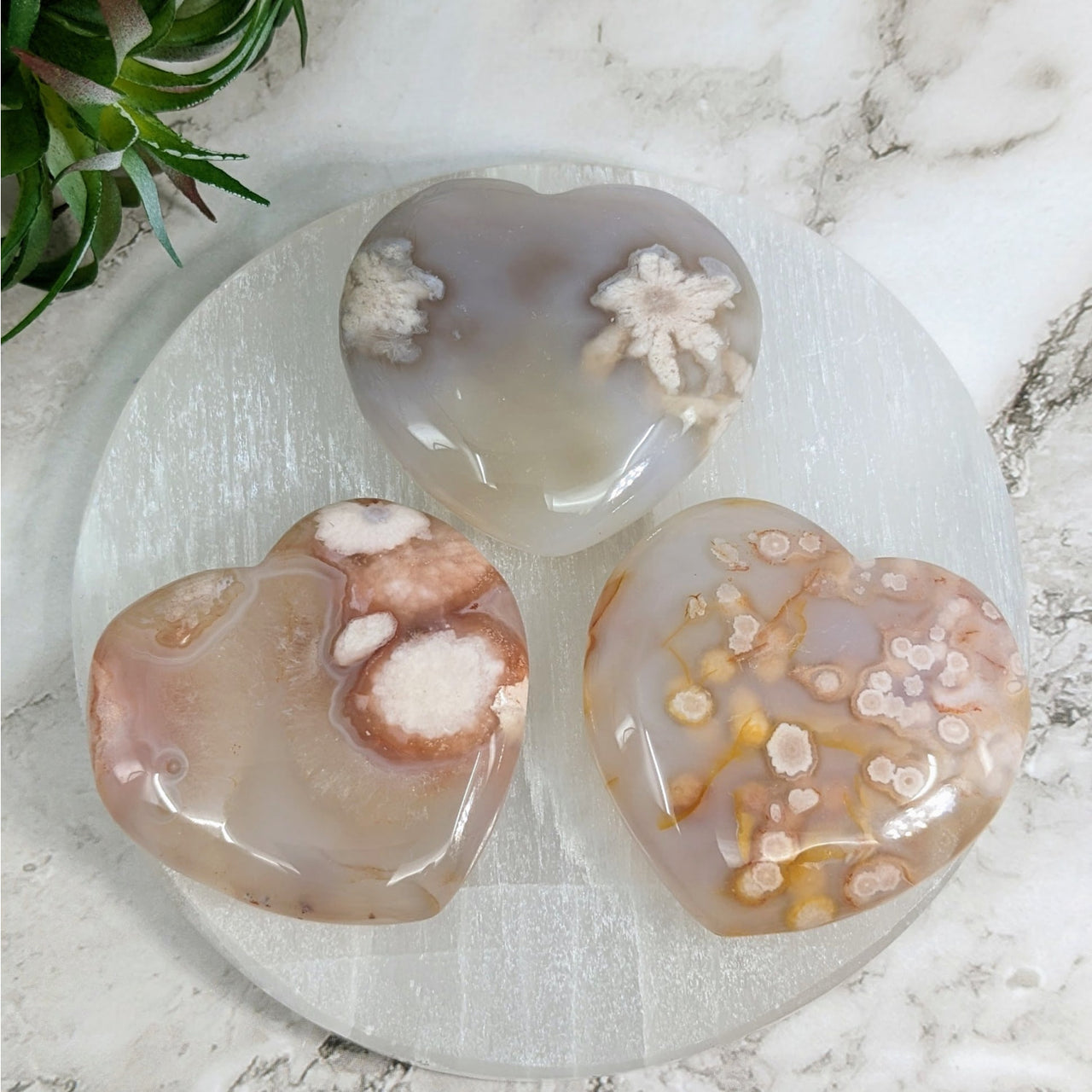 Three donuts on a plate on a marble table with Flower Agate 1.9’ Heart #LV4051