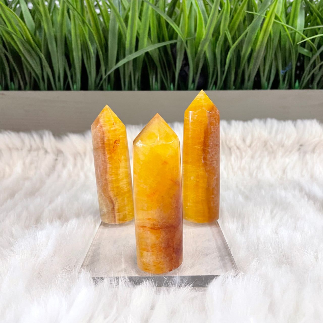 Fluorite Towers 2.5-3’: Two orange quartzite crystals on white fur rug