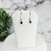 Thumbnail for Garnet Faceted Sterling Silver Dangle Earrings on white display stand #LV3248