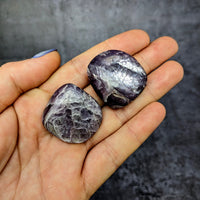 Thumbnail for Hand holding two tumbled amethite stones from Gem Lepidolite 1.2’ Tumbled Stone #SK9941