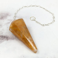 Thumbnail for Close-up of the Golden Healer Pendulum #J861, a stone pendulum on a chain