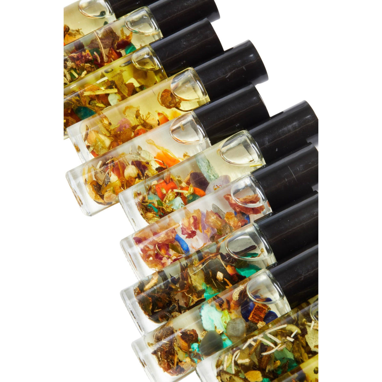 Small bottles of Good Luck Intention perfume with organic jojoba oil and colorful leaves