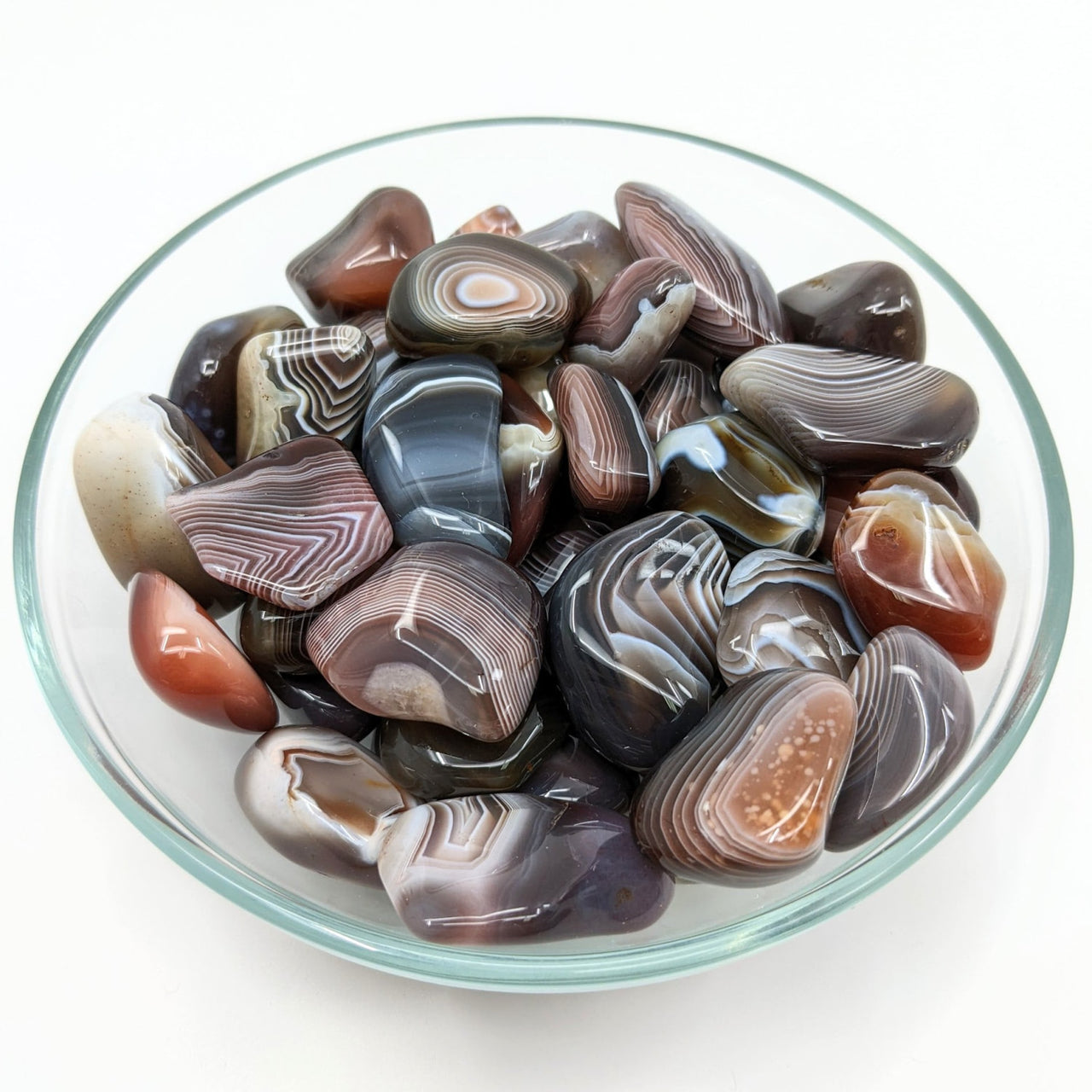 A bowl of colorful Gorgonzola Agate Large Tumbled Stones perfect for collections