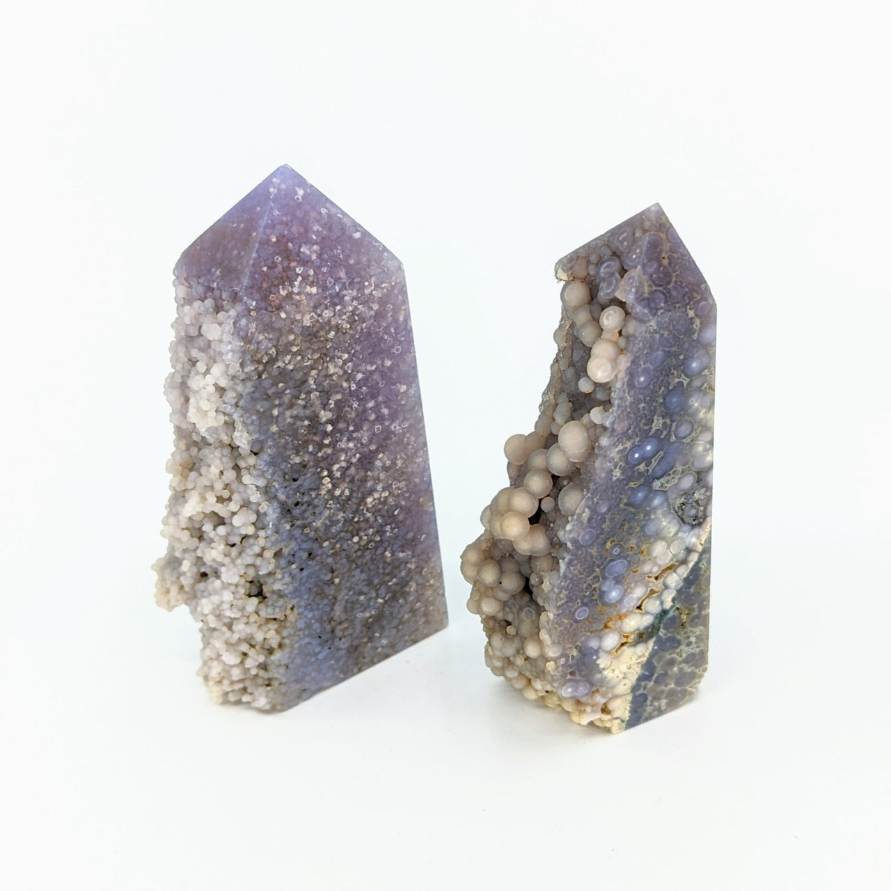 Two amethyst crystals with a white background - Grape Chalcedony Agate Tower #LV2728