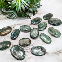 Thumbnail for A close-up of Green Kyanite palm stones on a table; product: Mini Palm #LV5136